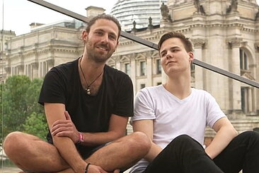 Standbild: die Studenten Linus und Efti im Interview vor dem Reichstag